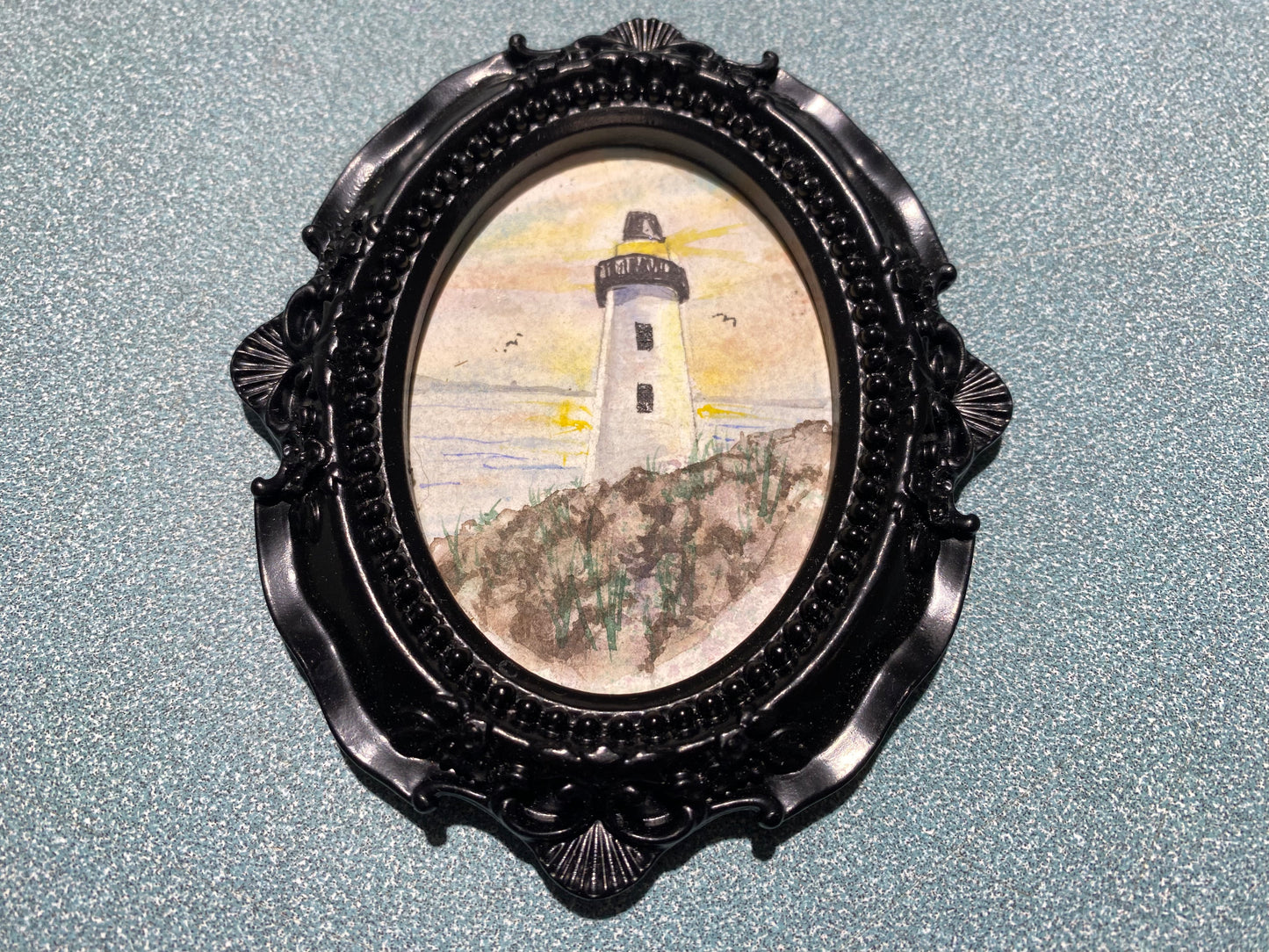 Lighthouse with Black Oval frame by Dominique LaVoie